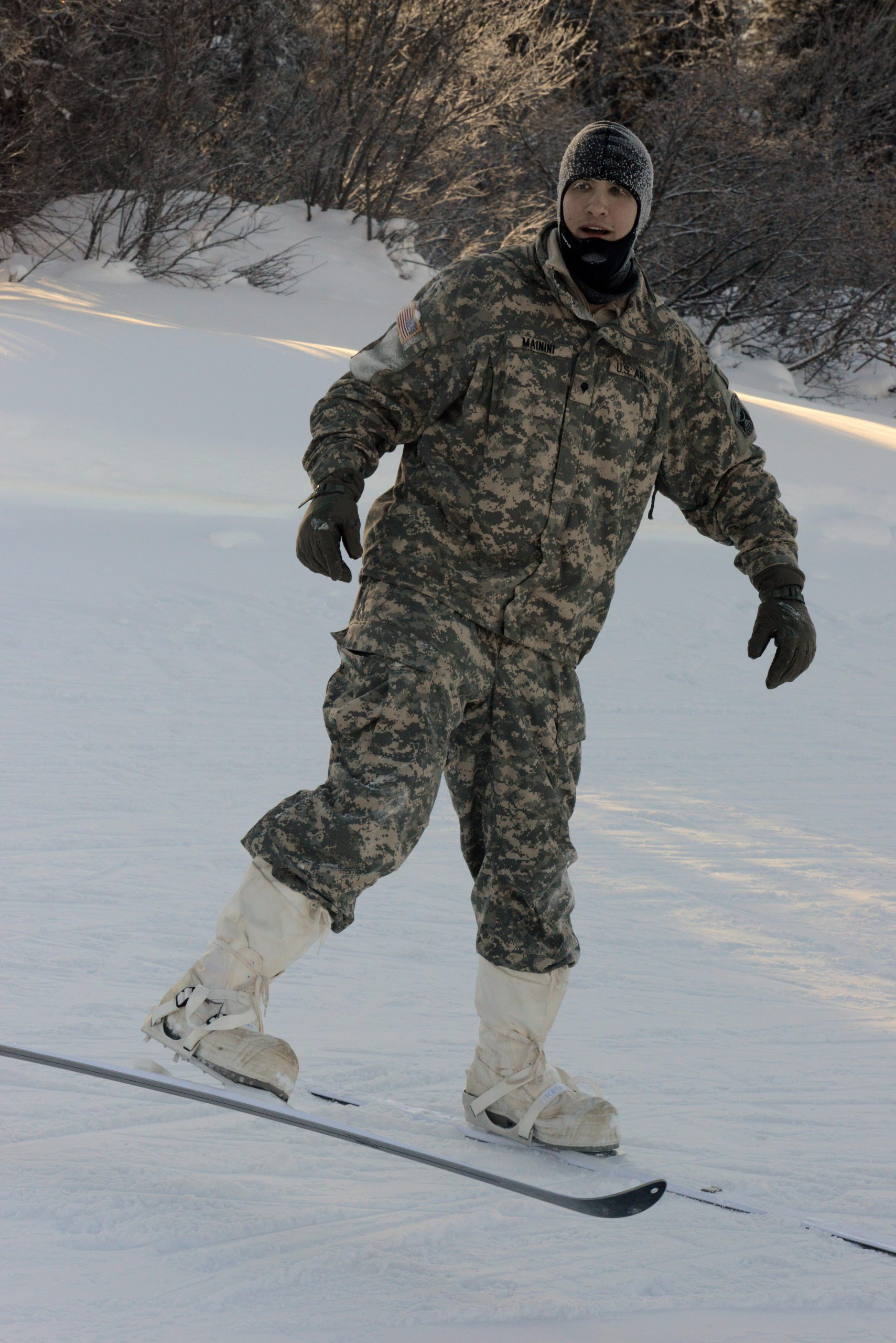 Army Spc. Elijah Mainini, a student at the Northern Warfare Training Center in Alaska, wears a size 16 boot and can't fit into a standard-issue Army vapor-barrier boot. He was issued Canadian forces mukluks and Jager skis. DoD photo by David Vergun. -