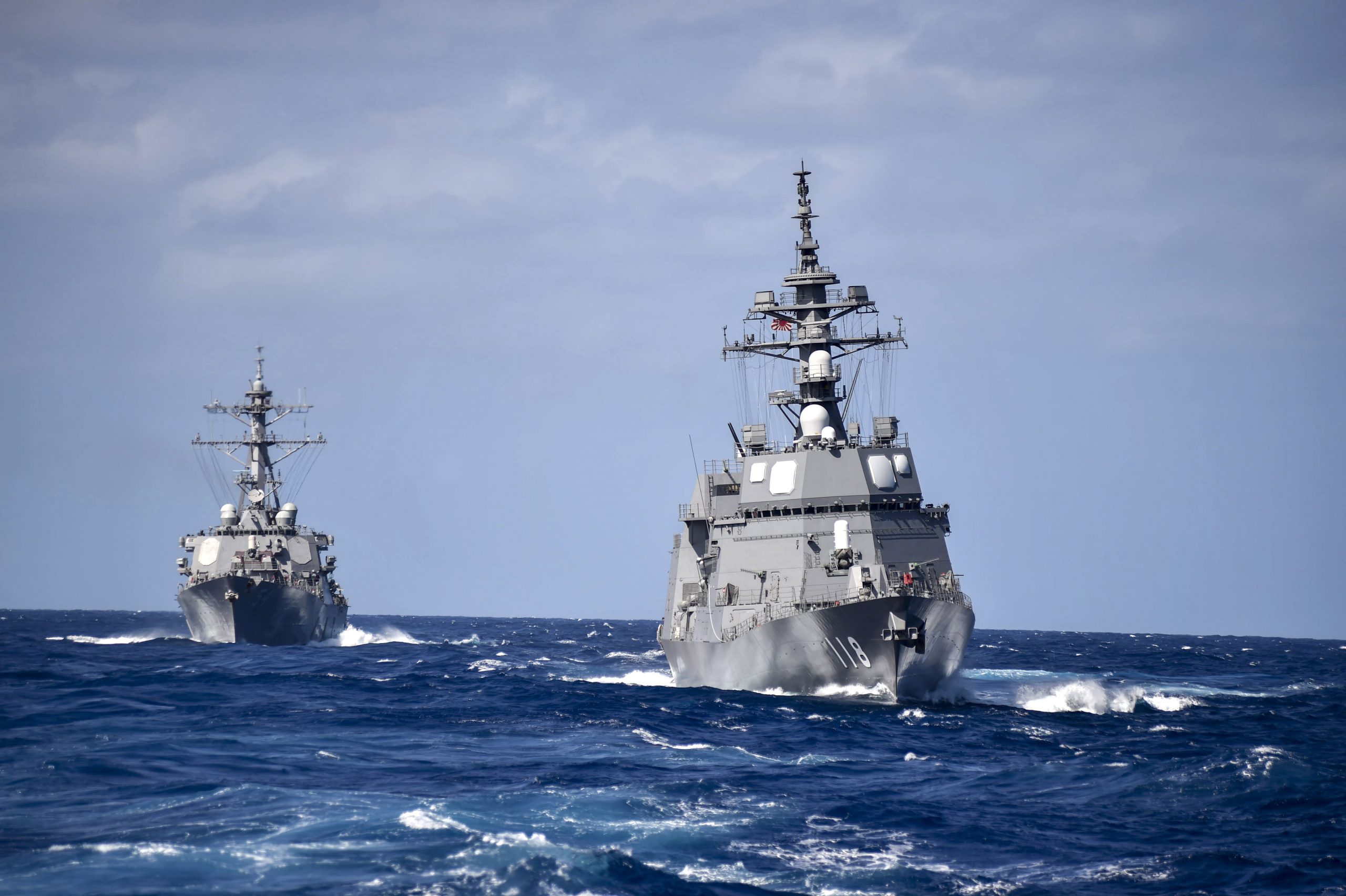 Philippine Sea(Feb. 28, 2018) The Arleigh Burke-class guided-missile destroyer USS Curtis Wilbur (DDG 54), left, sails in formation with the Japanese Maritime Self-Defense Force Akizuki-class destroyer JS Fuyuzuki (DD-118) during a close quarters maneuvering exercise. Curtis Wilbur is forward-deployed to the U.S. 7th Fleet area of operations in support of security and stability in the Indo-Pacific region. U.S. Navy photo by Mass Communication Specialist 1st Class Benjamin Dobbs. -