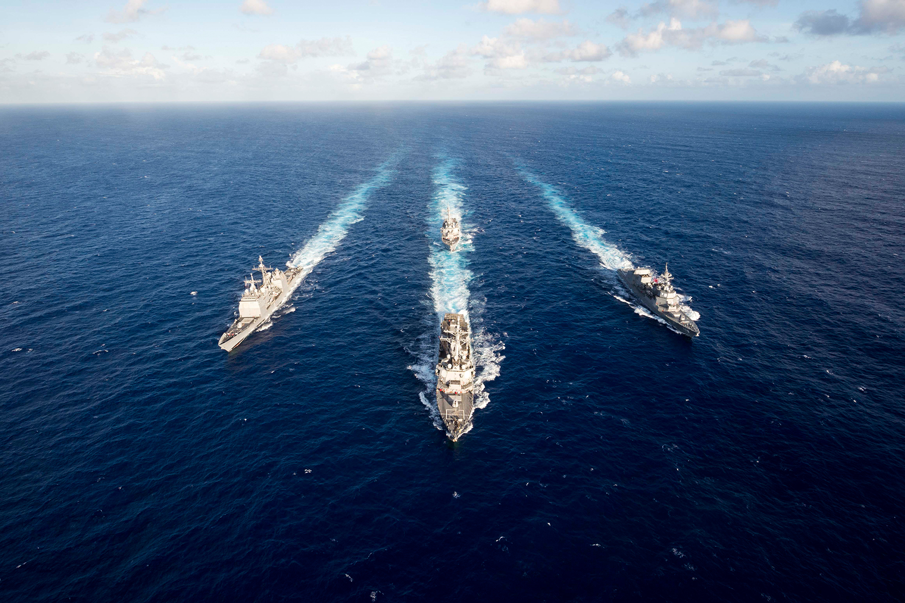The guided missile destroyer USS Mustin leads the guided missile cruiser USS Antietam, the guided missile destroyer USS Curtis Wilbur and the Japan Maritime Self-Defense Force destroyer JS Fuyuzuki in a formation at the completion of the MultiSail 2018 exercise in the Philippine Sea, March 14, 2018. MultiSail is a bilateral training exercise improving interoperability between the U.S. and Japanese forces. Navy photo by Petty Officer 3rd Class Sarah Myers -