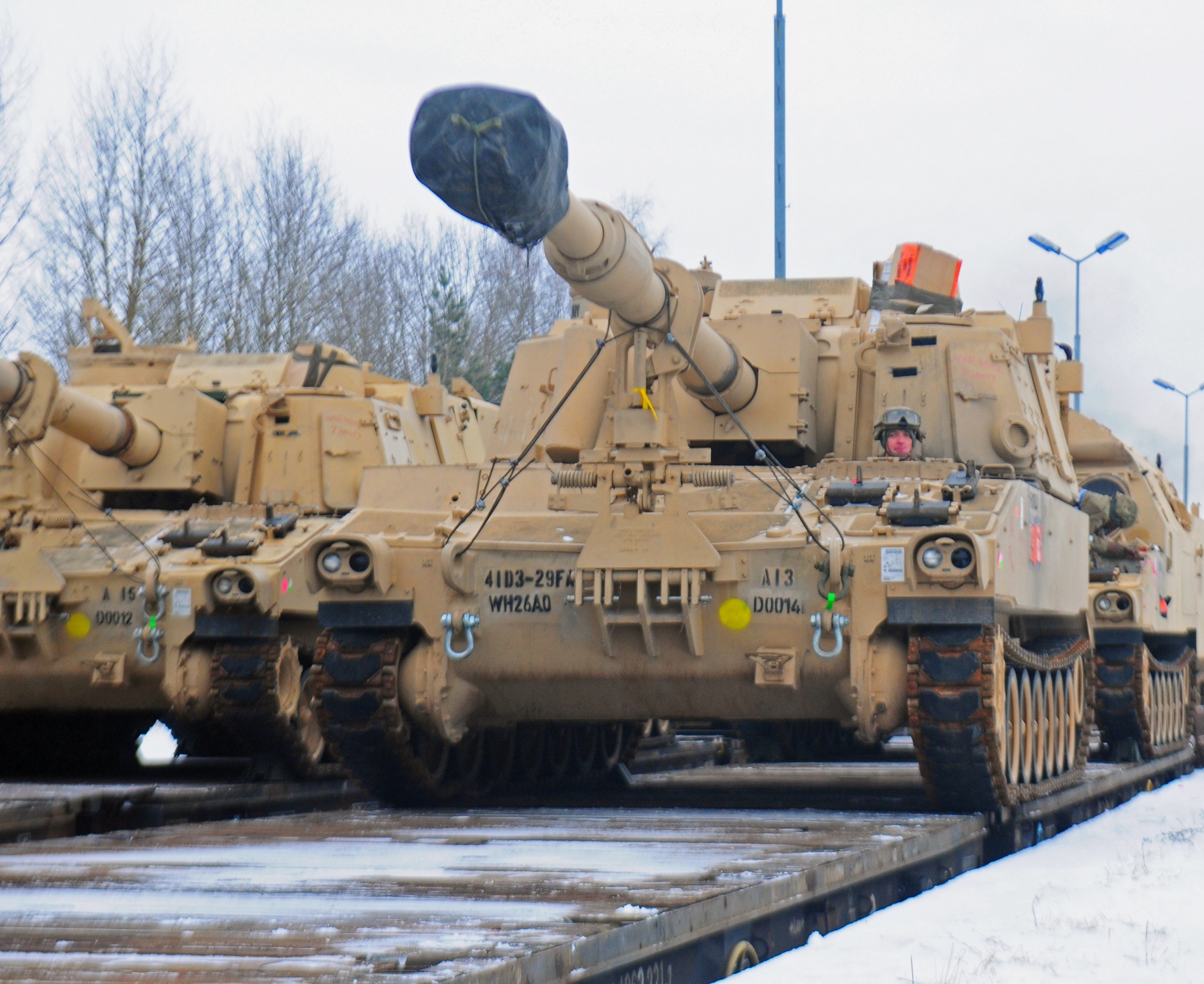 An American soldier from 3rd Battalion, 29th Field Artillery Regiment, 3rd Armored Brigade Combat Team, 4th Infantry Division, drives a M109 Paladin self-propelled howitzer off of a flatcar in Drawsko Pomorskie, Poland, Jan. 9, 2017. The howitzer was one of 53 vehicles that arrived in Northeastern Poland from the Port of Bremerhaven, Germany, as part of Operation Atlantic Resolve. Rotating units through the European theater enhances U.S. European Command’s ability to deter aggression and assure U.S. allies. Army photo by Staff Sgt. Corinna Baltos. -