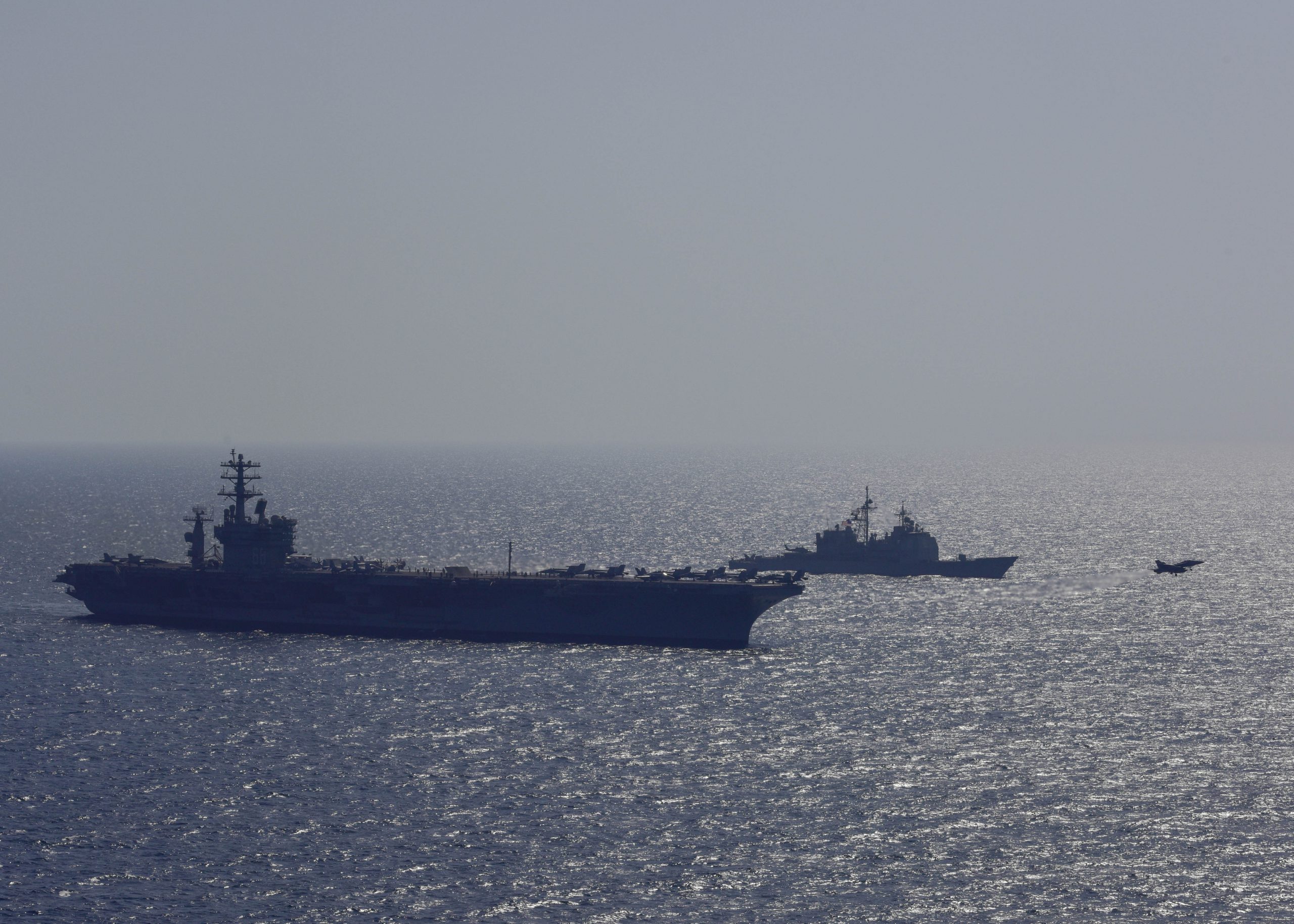 ARABIAN GULF (Oct. 20, 2017) The aircraft carrier USS Nimitz (CVN 68) and the Ticonderoga-class guided-missile cruiser USS Vella Gulf (CG 72) patrol alongside each other, Oct. 20, 2017, in the Arabian Gulf. Nimitz is deployed in the U.S. 5th Fleet area of operations in support of Operation Inherent Resolve. While in this region, the ship and strike group are conducting maritime security operations to reassure allies and partners, preserve freedom of navigation, and maintain the free flow of commerce. U.S. Navy photo by Mass Communication Specialist 2nd Class Austin Haist. -