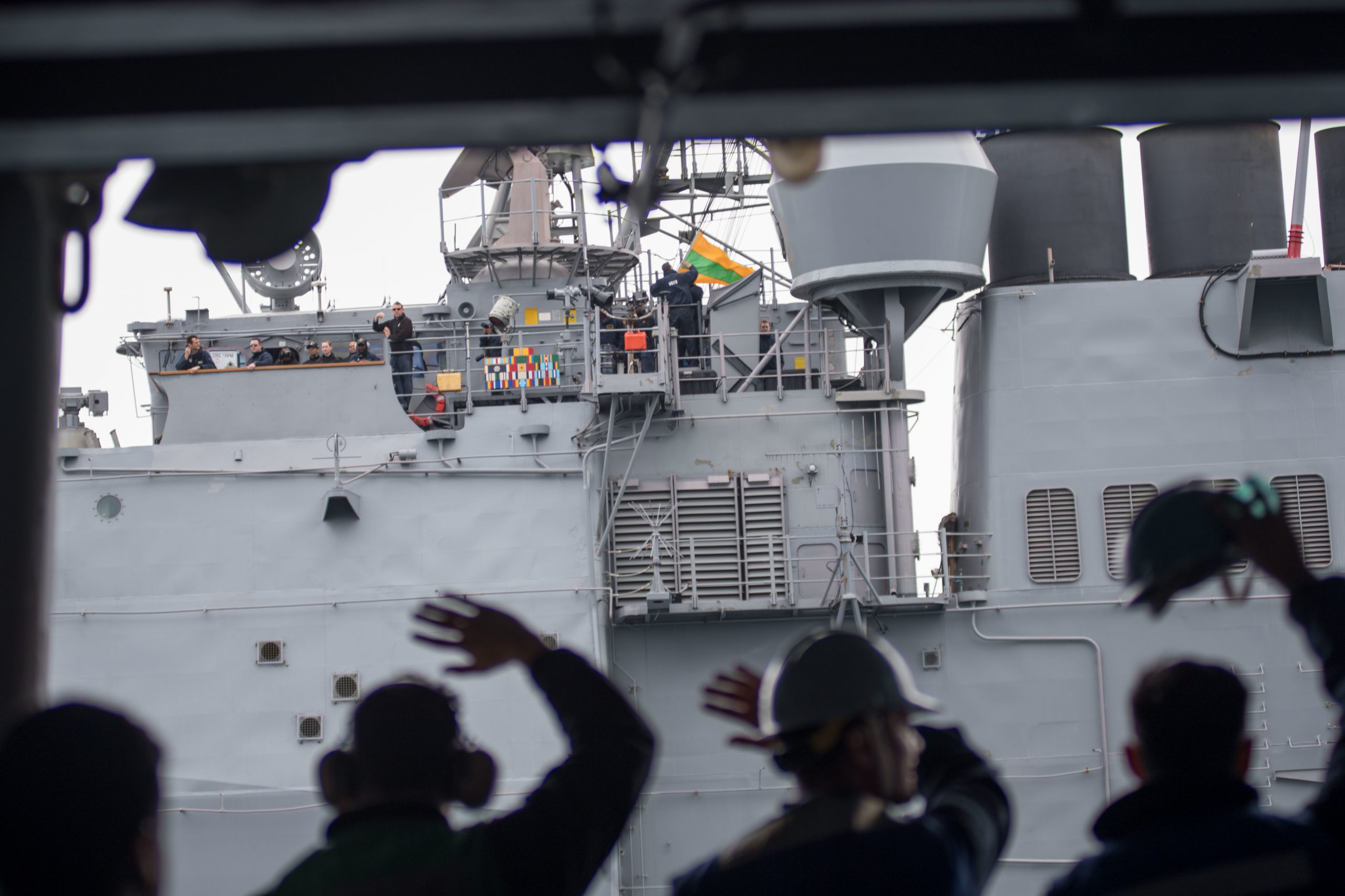 PACIFIC OCEAN (May 7, 2018) Sailors assigned to the aircraft carrier USS John C. Stennis (CVN 74) wave to Sailors aboard the Ticonderoga-class cruiser USS Mobile Bay (CG 53) during a replenishment-at-sea exercise. John C. Stennis is underway with the ships and squadrons of Carrier Strike Group (CSG) 3 conducting group sail training in preparation for its next scheduled deployment. U.S. Navy photo by Mass Communication Specialist 3rd Class William Ford. -