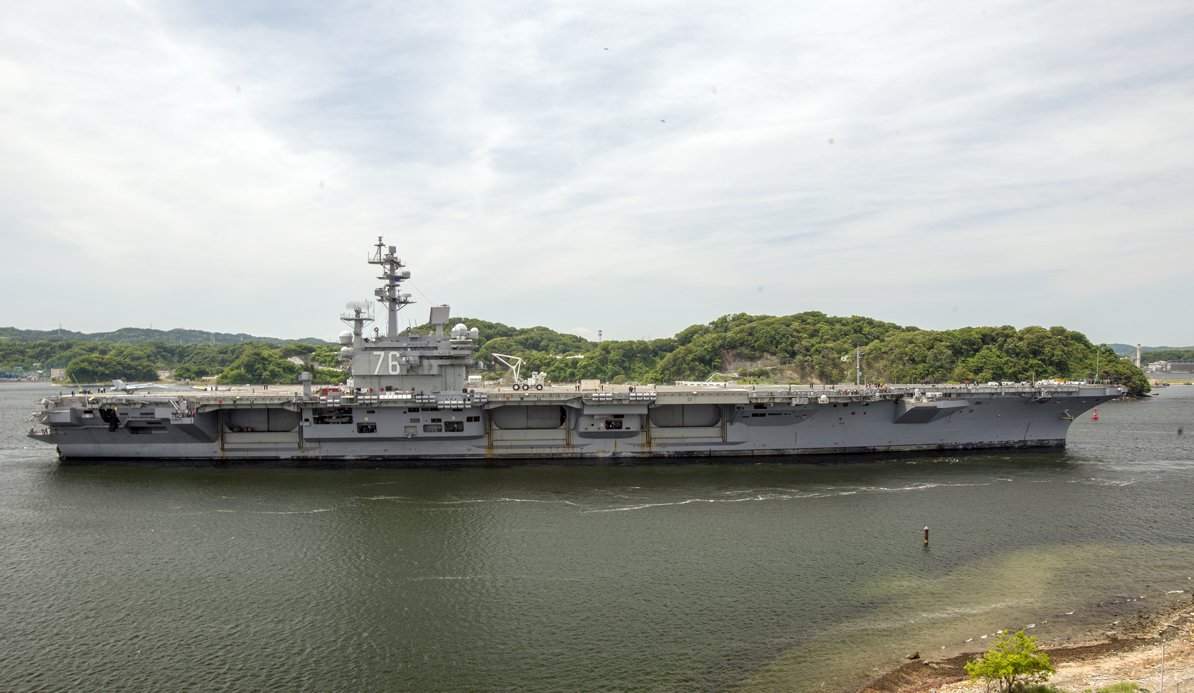 YOKOSUKA, Japan (May 11, 2018) The aircraft carrier USS Ronald Reagan (CVN 76) departs U.S. Fleet Activities (FLEACT) Yokosuka. FLEACT Yokosuka provides, maintains and operates base facilities and services in support of the U.S. 7th Fleet's forward-deployed naval forces, 71 tenant commands and more than 27,000 military and civilian personnel. U.S. Navy photo by Garrett Zopfi. -