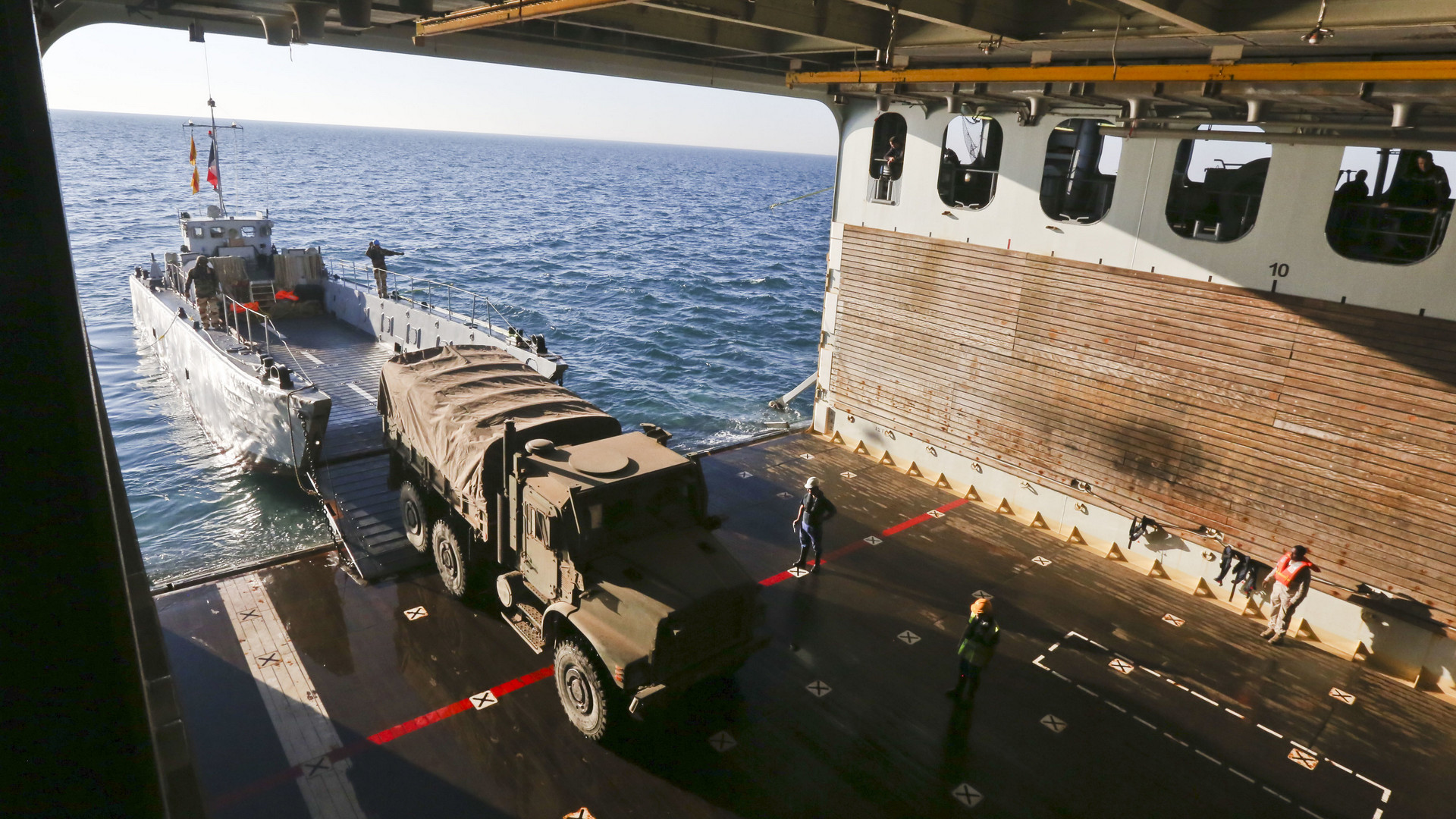 A French landing craft unit transports U.S. Marine Corps medium tactical vehicle replacement trucks during an amphibious offload with French forces aboard French amphibious assault ship LHD Tonnerre (L9014) -- Photo USMAC © Sgt. Jessica Lucio. -