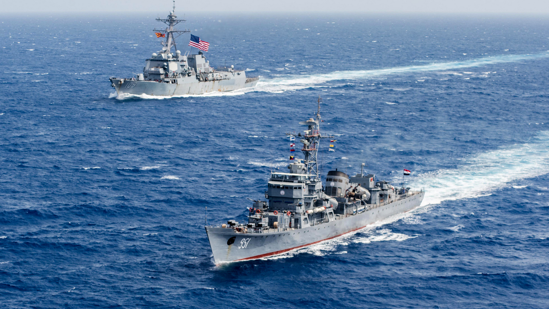 U.S. 5th Fleet Area of Operations : (July 1, 2018) The Egyptian navy frigate El Zafer (F951), bottom right, conducts a passing exercise with the guided-missile destroyer USS Jason Dunham (DDG 109). Jason Dunham is deployed to the U.S. 5th Fleet area of operations in support of naval operations to ensure maritime stability and security in the Central region, connecting the Mediterranean and the Pacific through the western Indian Ocean and three strategic choke points. U.S. Navy photo by Mass Communication Specialist 3rd Class Jonathan Clay -