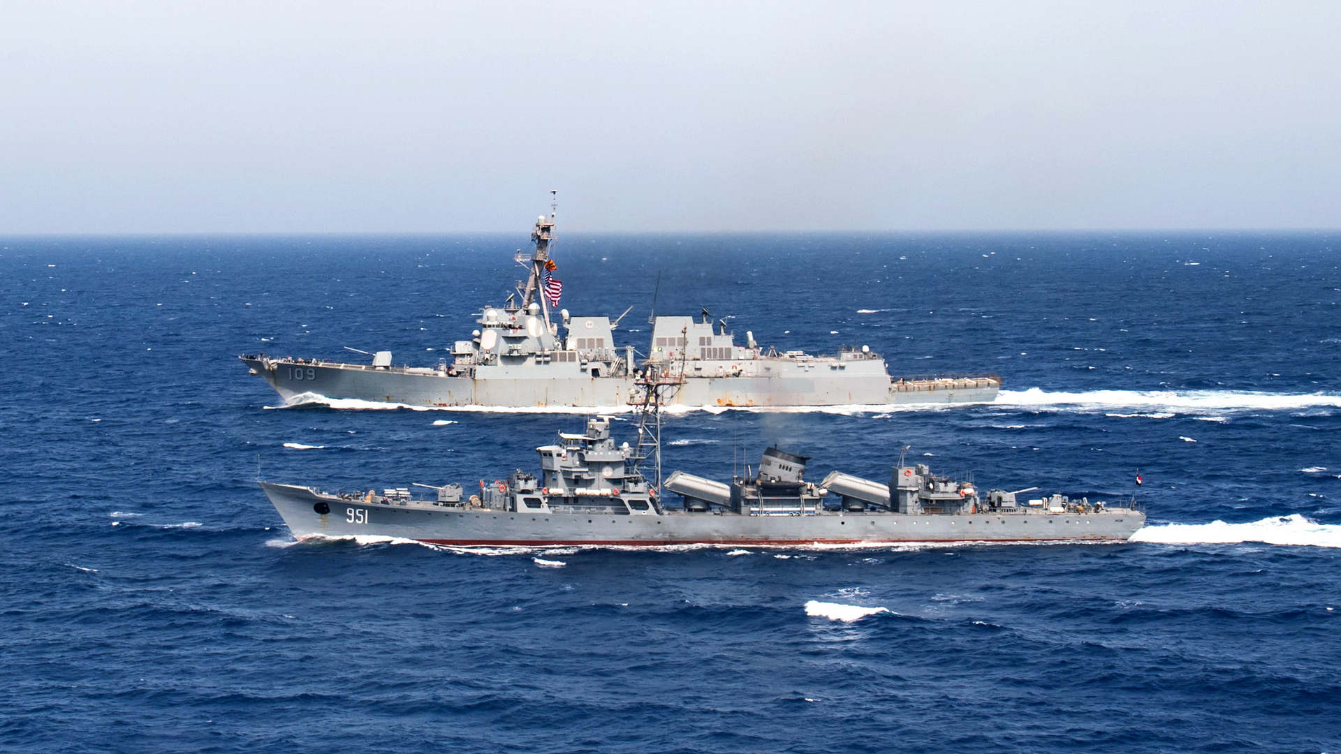 U.S. 5th Fleet Area of Operations : (July 1, 2018) The Egyptian navy frigate El Zafer (F951), bottom, steams alongside the guided-missile destroyer USS Jason Dunham (DDG 109) during a passing exercise. Jason Dunham is deployed to the U.S. 5th Fleet area of operations in support of naval operations to ensure maritime stability and security in the Central region, connecting the Mediterranean and the Pacific through the western Indian Ocean and three strategic choke points. (U.S. Navy photo by Mass Communication Specialist 3rd Class Jonathan Clay. -