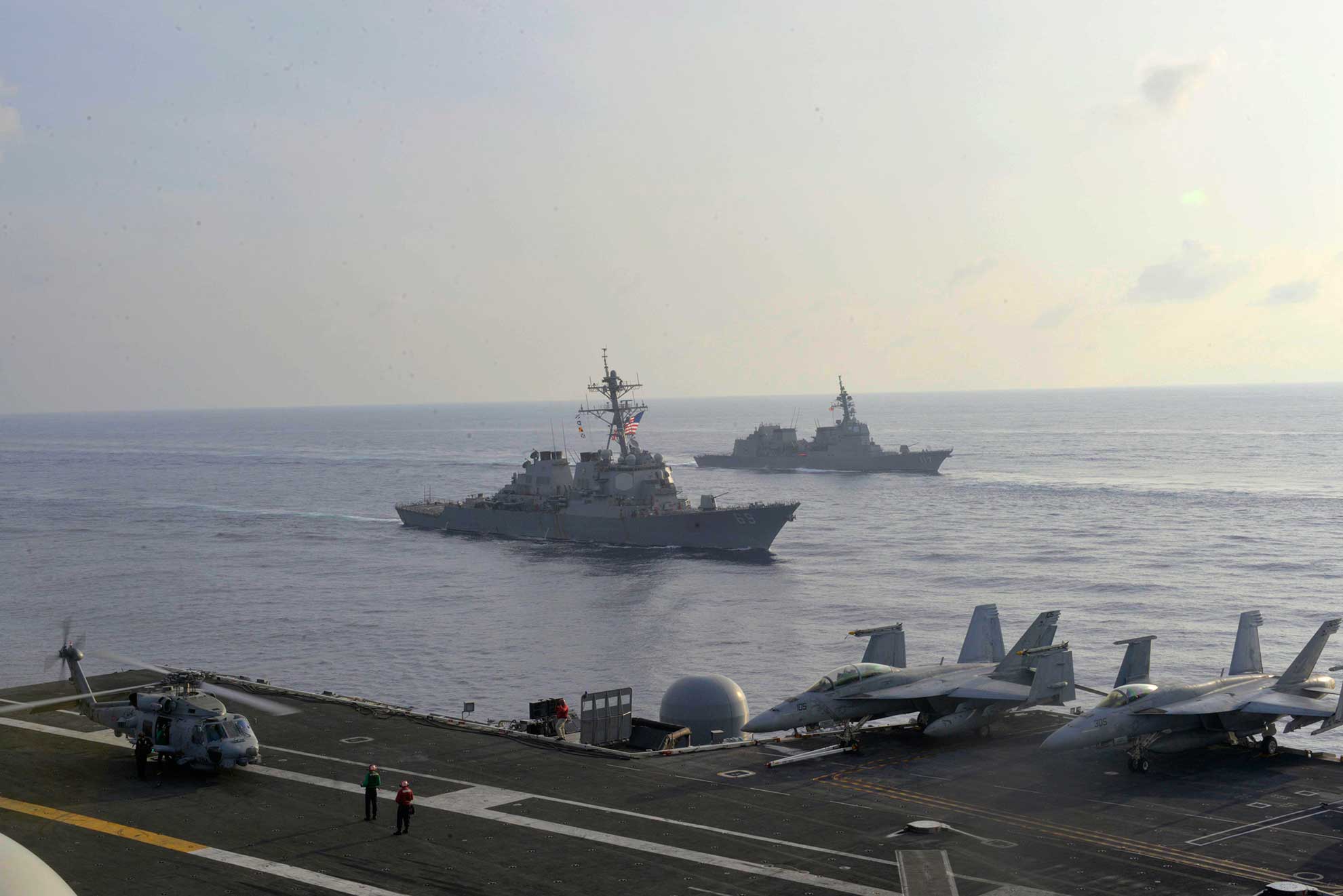 South China Sea (Aug. 31, 2018) The guided-missile destroyer USS Milius (DDG 69) and the Japan Maritime Self-Defense Force (JMSDF) destroyer JS Suzutsuki (DD 117) are underway alongside the Navy's forward aircraft carrier USS Ronald Reagan (CVN 76) during a photo exercise with the JMSDF. The Ronald Reagan Carrier Strike Group is forward-deployed to the U.S. 7th Fleet area of operations in support of security and stability in the Indo-Pacific region -- U.S. Navy photo by MCS1 Timothy M. Black. -