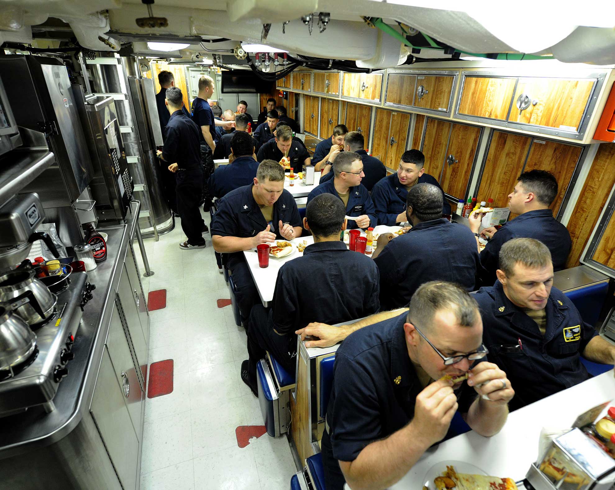 Atlantic Ocean (June 23, 2018) Sailors assigned to the Virginia-class fast attack submarine Pre-Commissioning Unit (PCU) Indiana (SSN 789) eat dinner in the crew's mess while underway. Indiana is the 16th Virginia-class fast attack submarine and is scheduled to be commissioned Sept. 29, 2018 -- U.S. Navy photo by Chief MCS Darryl Wood. -