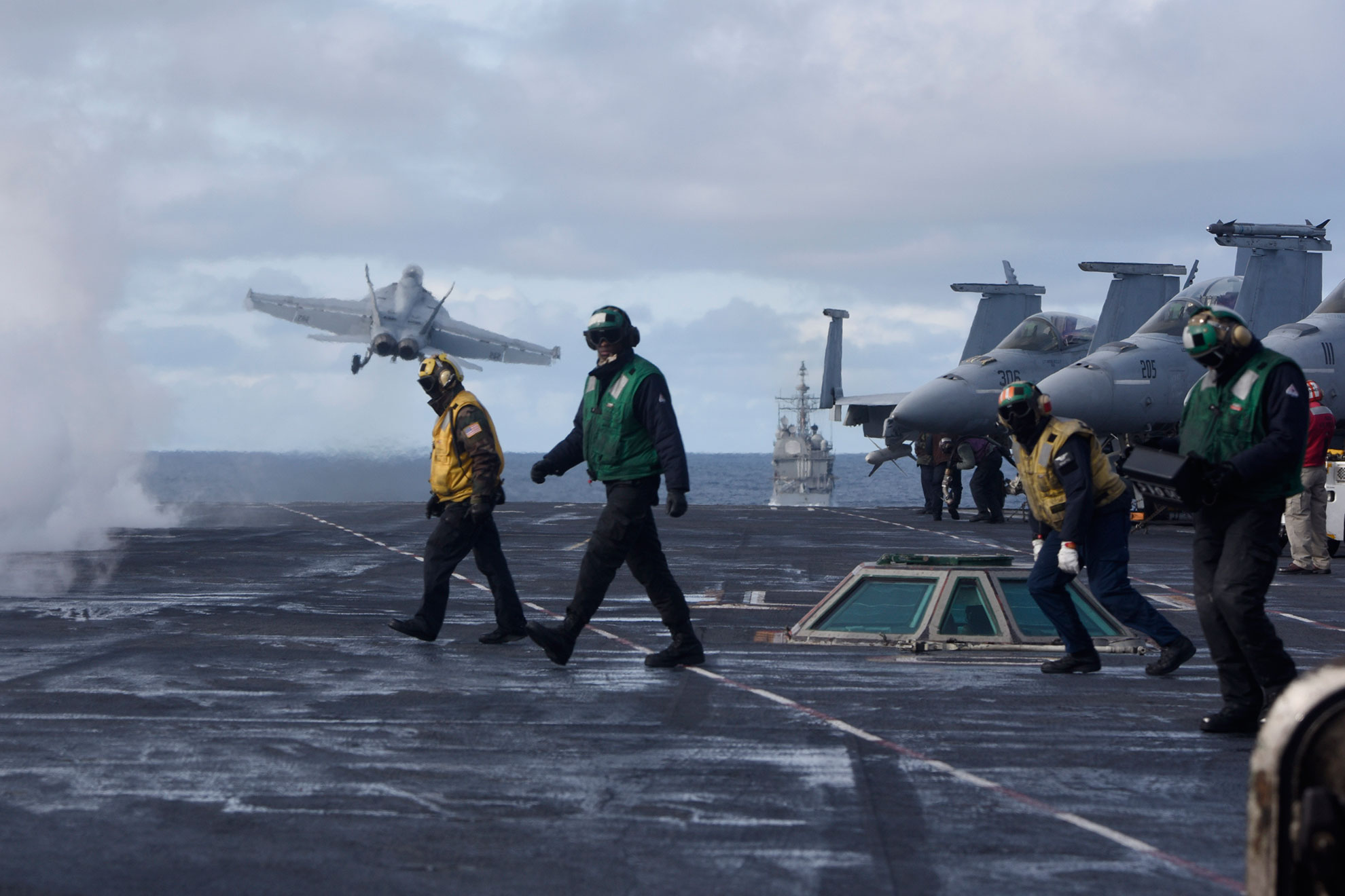 North Atlantic (Sept. 18, 2018) Sailors stand on the flight deck after launching an F/A-18F Super Hornet assigned to the "Fighting Checkmates" of Strike Fighter Squadron (VFA) 211 aboard the Nimitz-class aircraft carrier USS Harry S. Truman (CVN 75) in the North Atlantic, Sept. 18, 2018. The Harry S. Truman Carrier Strike Group is deployed to the U.S. 6th Fleet area of operations, demonstrating commitment to regional allies and partners, combat power, and flexibility of U.S. naval forces to operate wherever and whenever the nation requires -- U.S. Navy photo by MCS2 Anthony Flynn. -