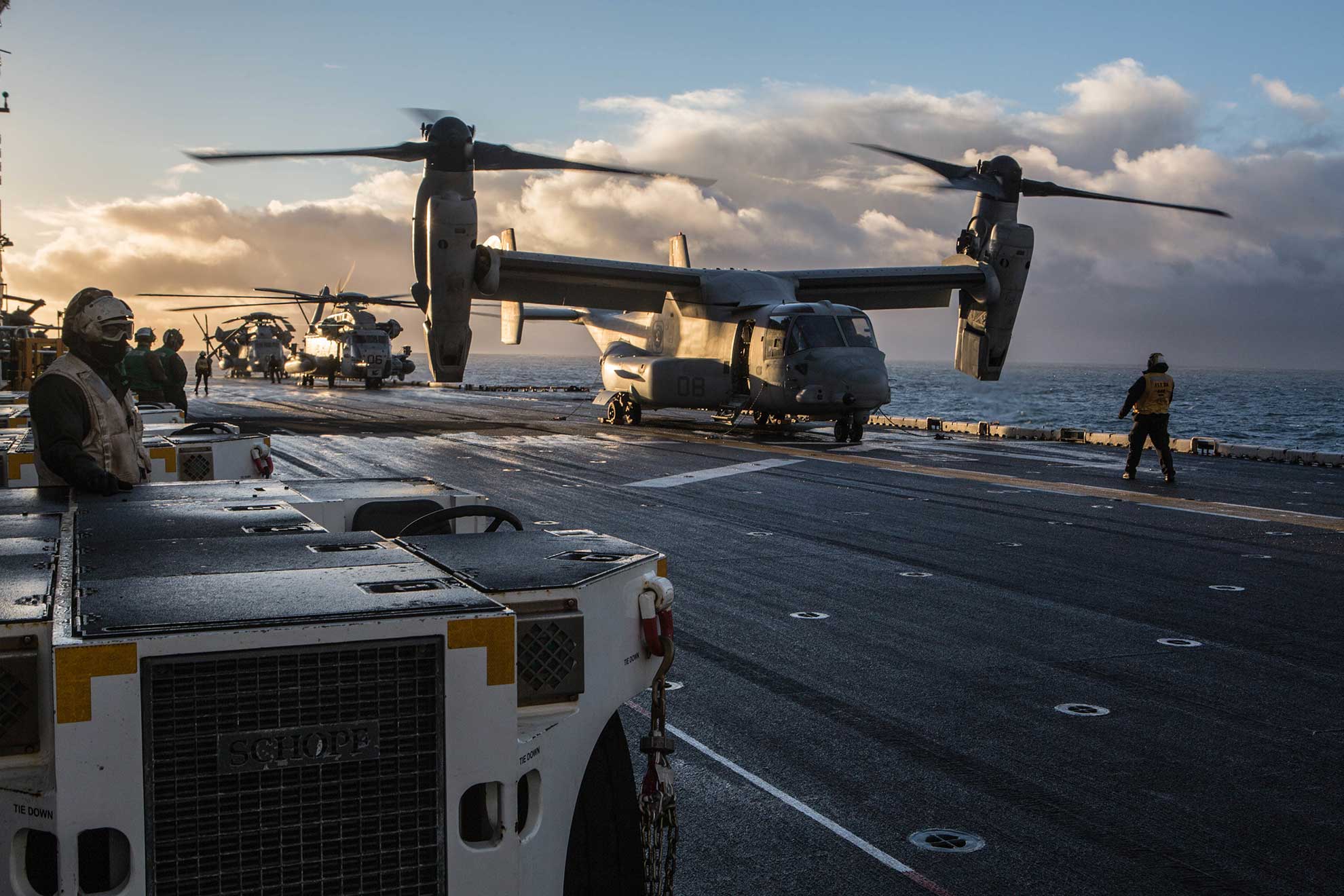 Keflavik, Iceland (Oct. 17, 2018) A U.S. Marine Corps V-22 Osprey and a CH-53 Sea Stallion helicopter prepare for takeoff aboard amphibious assault ship USS Iwo Jima (LHD 7), Oct 17, 2018 in preparation for exercise Trident Juncture 2018. Trident Juncture is a planned exercise to enhance U.S. and NATO partners' and Allies' ability to work together collectively and conduct military operations under challenging conditions -- U.S. Marine Corps photo by Lance Cpl. Brennon A. Taylor. -