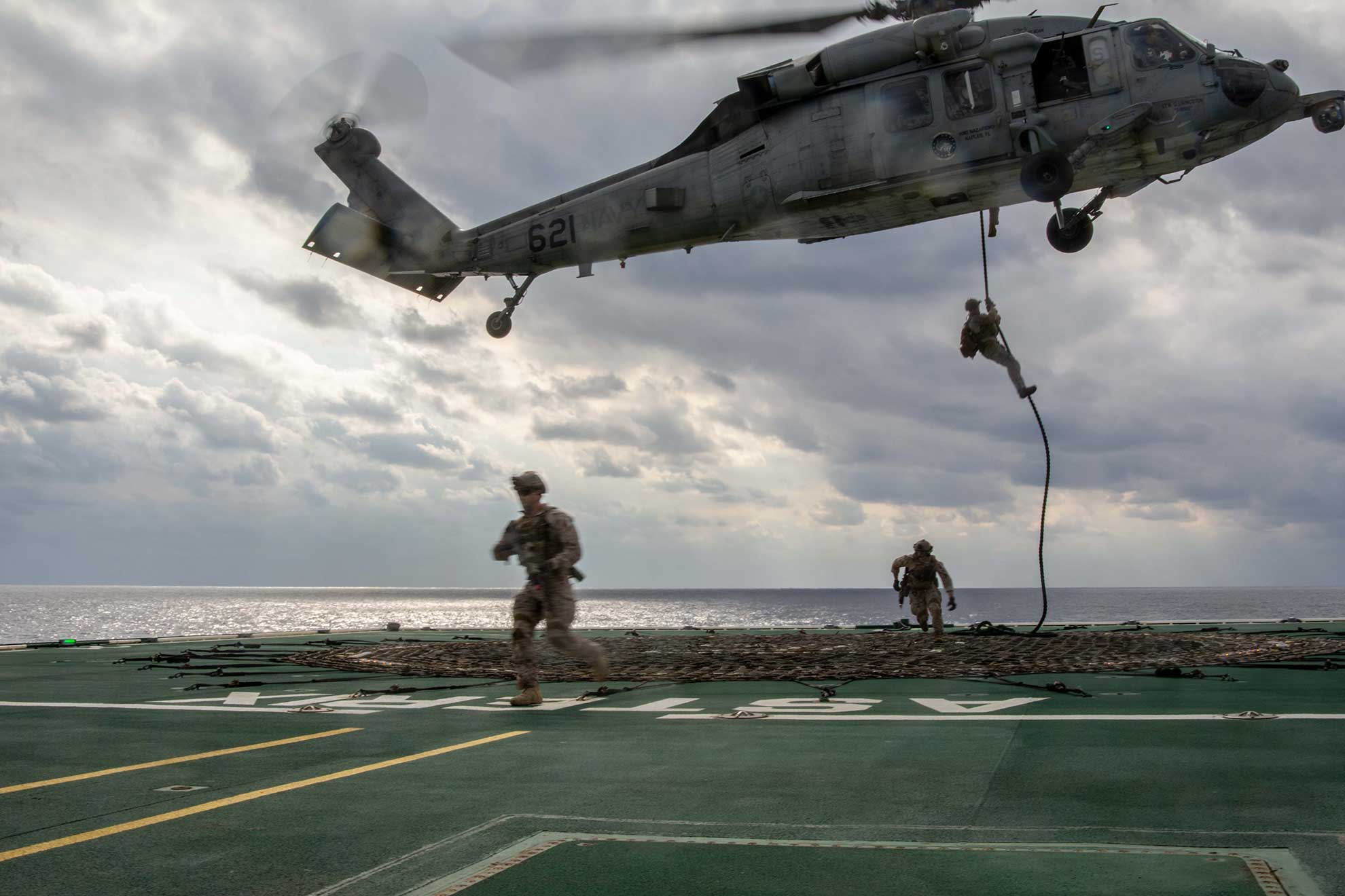 Philippine Sea (Nov. 1, 2018) Sailors assigned to Explosive Ordnance Disposal Unit 5, fast rope from an MH-60S Seahawk helicopter, assigned to Helicopter Sea Combat (HSC) 12, aboard the forward-deployed aircraft carrier USS Ronald Reagan (CVN 76) during exercise Keen Sword 19. Keen Sword is a joint, bilateral field-training exercise involving U.S. military and Japan Maritime Self-Defense Force personnel, designed to increase combat readiness and interoperability of the Japan-U.S. alliance -- U.S. Navy photo by MCS3 Erwin Jacob V. Miciano. -