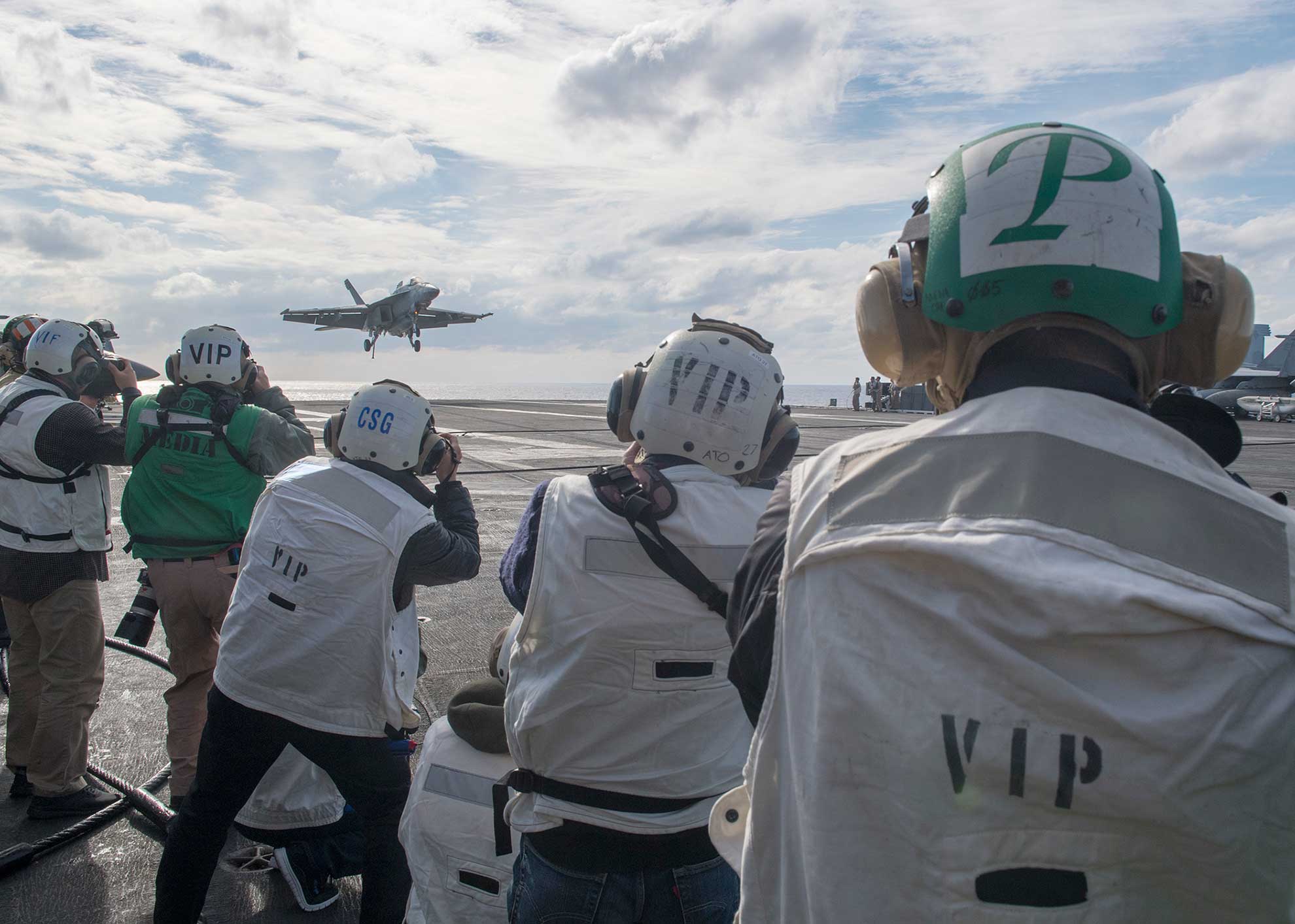 Philippine Sea (Nov. 3, 2018) Members of the Japanese media take photos of flight operations aboard the aircraft carrier USS Ronald Reagan (CVN 76) during exercise Keen Sword 19. Keen Sword is a joint, bilateral field-training exercise involving U.S. military and Japan Maritime Self-Defense Force personnel, designed to increase combat readiness and interoperability of the Japan-U.S. alliance -- U.S. Navy photo by MCS1 Richard L.J. Gourley. -