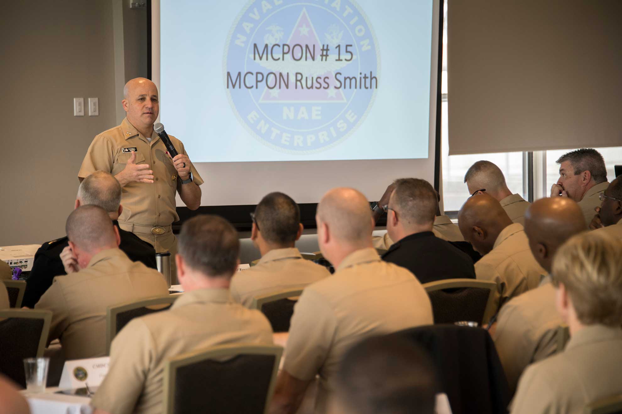 North Island, Calif. (Nov. 5, 2018) Master Chief Petty Officer of the Navy (MCPON) Russell Smith addresses the audience at the Naval Aviation Enterprise 2018 Command Master Chief/Senior Enlisted Leadership and Spouse Training Symposium. The conference brought enlisted leaders and their spouses together to discuss command level policies that support Sailors and their families -- U.S. Navy photo by MCS1 Luke Perry. -