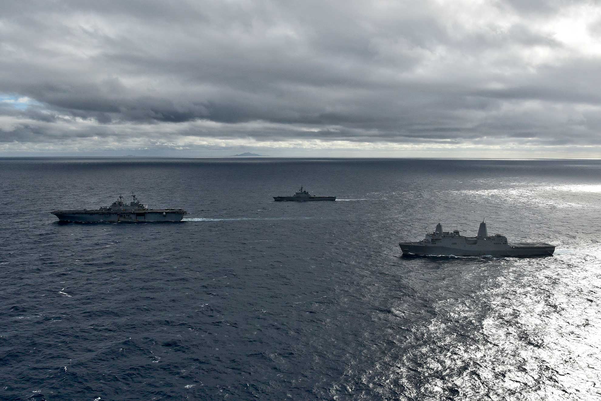 East China sea (Jan. 12, 2019) The amphibious assault ship USS Wasp (LHD 1), left, the Japan Maritime Self-Defense Force amphibious transport dock ship JS Kunisaki (LST 4003), and the amphibious transport dock ship USS Green Bay (LPD 20), right, transit in formation during a cooperative deployment. Wasp, flagship of Wasp Amphibious Ready Group, is operating in the Indo-Pacific region to enhance interoperability with partners and serve as a ready-response force for any type of contingency -- U.S. Navy photo by MCS1 Class Daniel Barker. -
