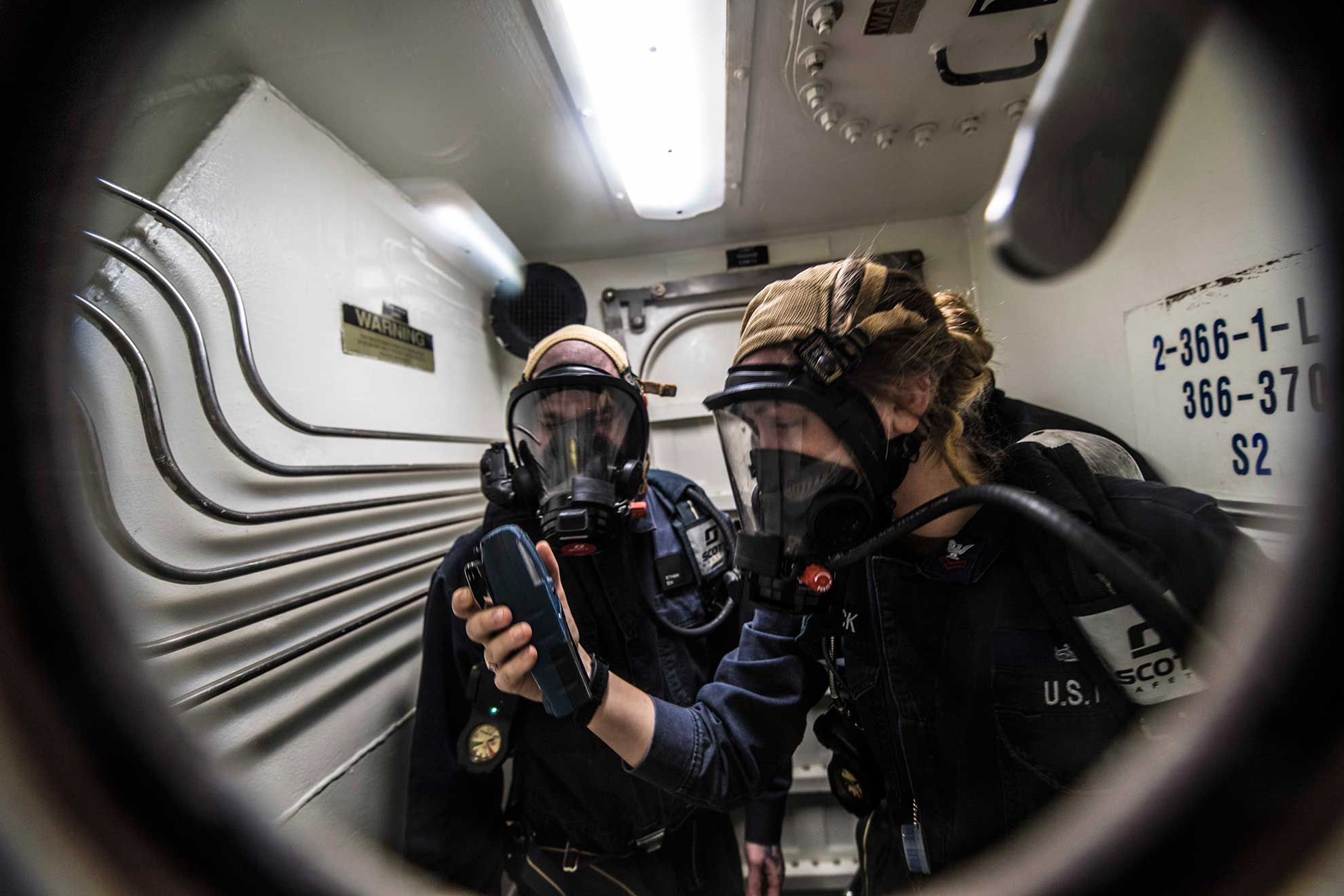 Plymouth, England (Feb. 9, 2019) Damage Controlman 2nd Class Stephanie Buttrick, right uses a toxic-gas detector with Electrician's Mate 2nd Class Ethan Silva aboard the Arleigh Burke-class guided-missile destroyer USS Porter (DDG 78) during a drill in Plymouth, England, Feb. 9, 2019. Porter, forward-deployed to Rota, Spain, is on its sixth patrol in the U.S. 6th Fleet area of operations in support of U.S national security interests in Europe and Africa -- U.S. Navy photo by MCS2 James R. Turner. -
