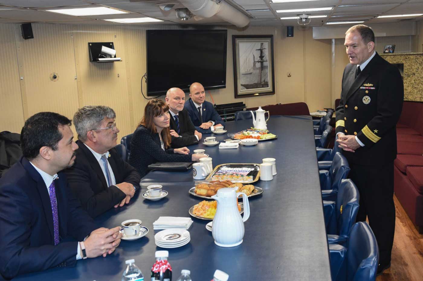 Rostock, Germany (Mar. 4, 2019) Rear Adm. Edward Cashman, commander of Standing Maritime Group One (SNMG 1) speaks to Consul General Yoneoka and other distinguished visitors from Hamburg and Rostock, Germany during a tour aboard the guided-missile destroyer USS Gravely (DDG 107). Gravely is underway on a regularly-scheduled deployment as the flagship of Standing NATO Maritime Group 1 to conduct maritime operations and provide a continuous maritime capability for NATO in the northern Atlantic -- U.S. Navy photo by MCS 2nd Class Mark Andrew Hays. -