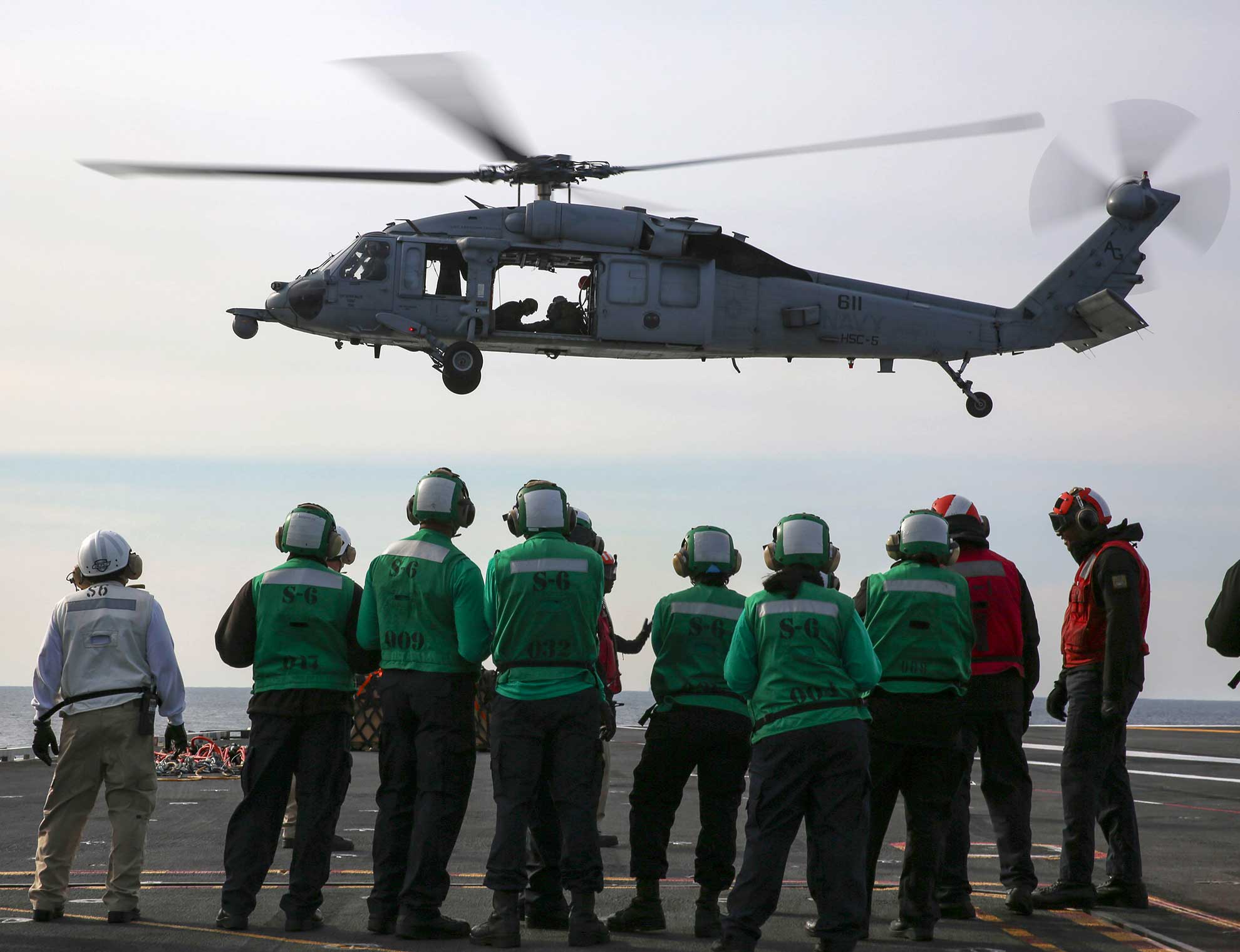 Atlantic Ocean (April 4, 2019) Sailors aboard the Nimitz-class aircraft carrier USS Abraham Lincoln (CVN 72) watch as an MH-60S Sea Hawk helicopter from Helicopter Sea Combat Squadron (HSC) 5 participates in a replenishment-at-sea with the fast combat support ship USNS Arctic (T-AOE 8). Abraham Lincoln is underway as part of the Abraham Lincoln Carrier Strike Group (ABECSG) deployment in support of maritime security cooperation efforts in the U.S. 5th, 6th and 7th Fleet areas of responsibility. With Abraham Lincoln as the flagship, deployed strike group assets include staffs, ships and aircraft of Carrier Strike Group 12 (CSG 12), Destroyer Squadron 2 (DESRON 2), USS Leyte Gulf (CG 55) and Carrier Air Wing 7 (CVW 7); as well as Alvaro de Bazan-class frigate ESPS M©ndez Nez (F 104) -- U.S. Navy photo by MCS 3rd Class Jeremiah Bartelt. -