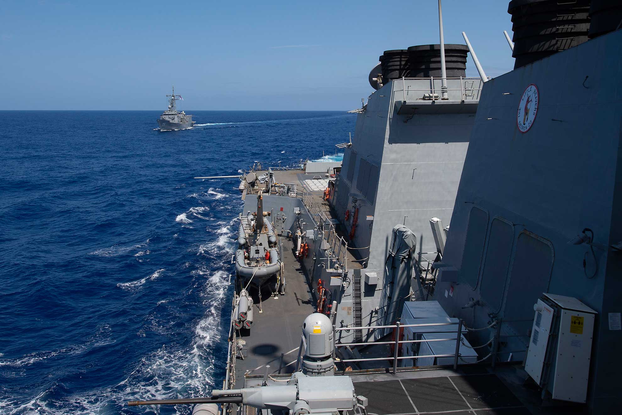 Philippine Sea (April 18, 2019) The Arleigh Burke-class guided-missile destroyer USS Preble (DDG 88) and the Royal Australian Navy Adelaide-class guided-missile frigate HMAS Melbourne (FFG 05) transit in formation during a cooperative deployment. Preble and Melbourne are participating in a cooperative deployment in order to improve on maritime capabilities between partners. Preble is deployed to the U.S 7th Fleet area of operations in support of security and stability in the Indo-Pacific region. (U.S. Navy photo by MCS 1st Class Bryan Niegel. -