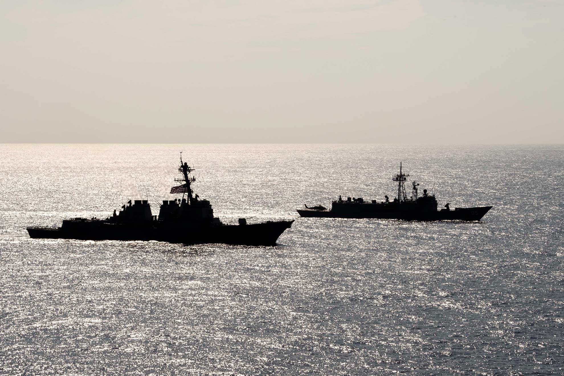 Philippine Sea (April 18, 2019) The Arleigh Burke-class guided-missile destroyer USS Preble (DDG 88) and the Royal Australian Navy Adelaide-class guided-missile frigate HMAS Melbourne (FFG 05) transit in formation during a cooperative deployment. Preble and Melbourne are participating in a cooperative deployment in order to improve on maritime capabilities between partners. Preble is deployed to the U.S 7th Fleet area of operations in support of security and stability in the Indo-Pacific region -- U.S. Navy photo by MCS 1st Class Bryan Niegel. -