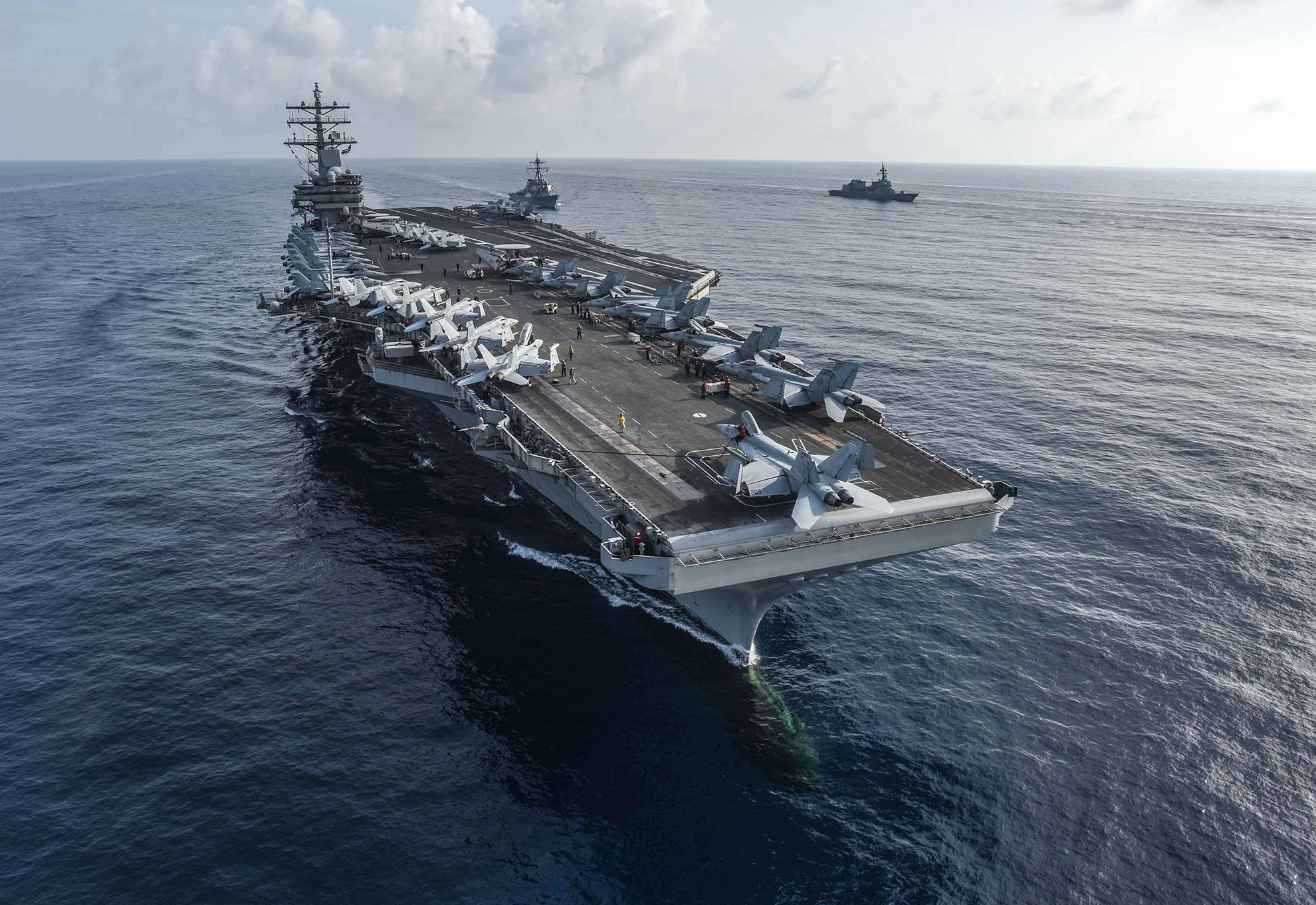 South China Sea (Aug. 31, 2018) The aircraft carrier USS Ronald Reagan (CVN 76) and the guided-missile destroyer USS Milius (DDG 69), center, conduct a photo exercise with Japan Maritime Self-Defense Force ships. The Ronald Reagan Carrier Strike Group is forward-deployed to the U.S. 7th Fleet area of operations in support of security and stability in the Indo-Pacific region -- U.S. Navy photo by MCS2 Kaila V. Peters. -