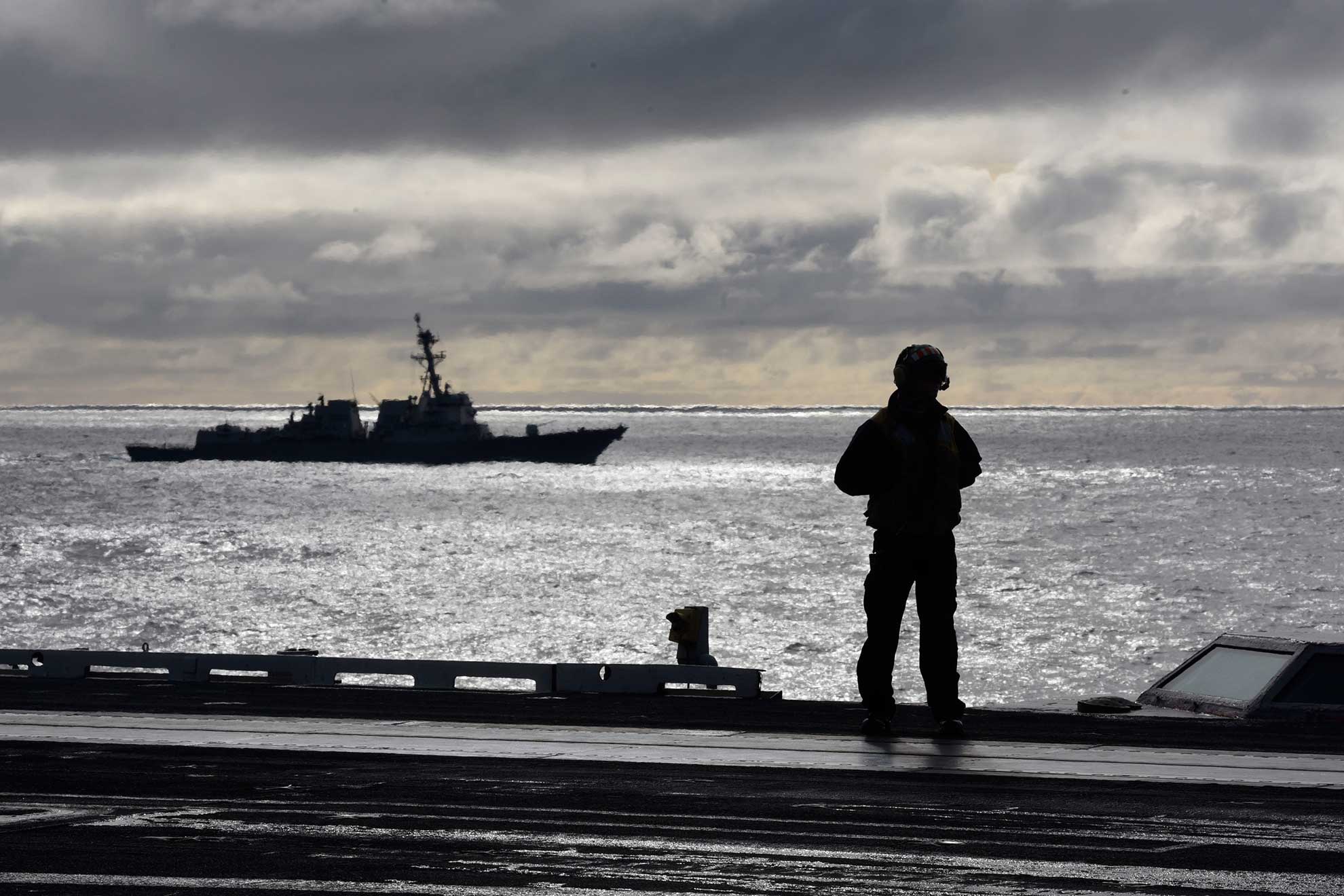 North Atlantic (Sept. 18, 2018) A Sailor stands on the flight deck during flight operations aboard the Nimitz-class aircraft carrier USS Harry S. Truman (CVN 75) in the North Atlantic, Sept. 18, 2018. The Harry S. Truman Carrier Strike Group is deployed to the U.S. 6th Fleet area of operations, demonstrating commitment to regional allies and partners, combat power, and flexibility of U.S. naval forces to operate wherever and whenever the nation requires -- U.S. Navy photo by MCS2 Anthony Flynn. -