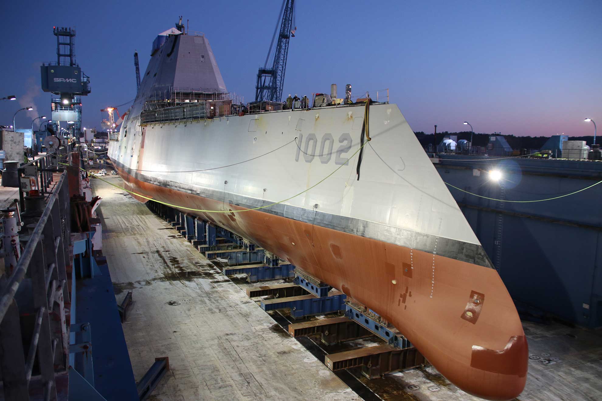 Bath, Maine (Dec. 9, 2018) Following a multi-day process that includes moving the ship from the land level facility to the dry dock, the future USS Lyndon B. Johnson (DDG 1002) is made ready before flooding of the dry dock at General Dynamic-Bath Iron Works shipyard, and subsequent launching of the third Zumwalt-class destroyer -- U.S. Navy photo courtesy of General Dynamics-Bath Iron Works. -